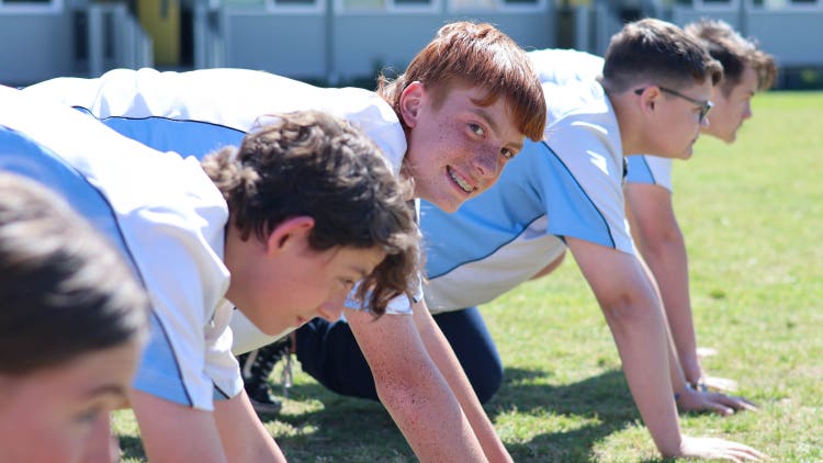 Students line up for a running race on the oval.