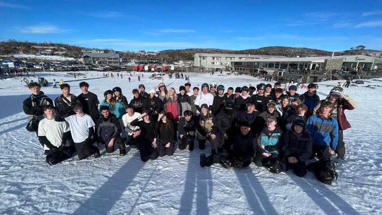 A group photo of students in the snow.