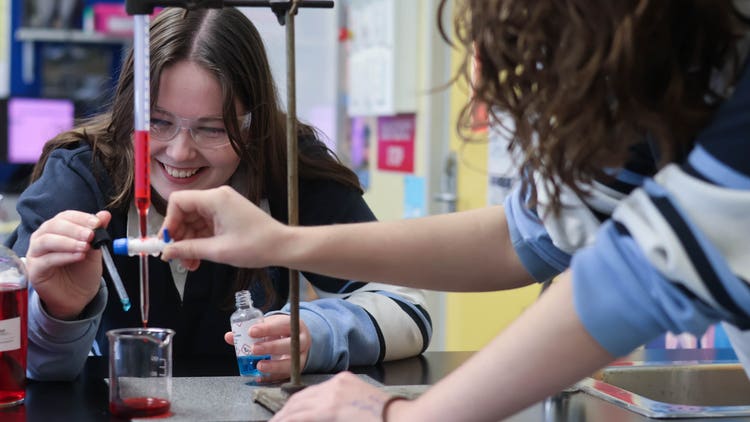 Students in Science lab doing an experiment.