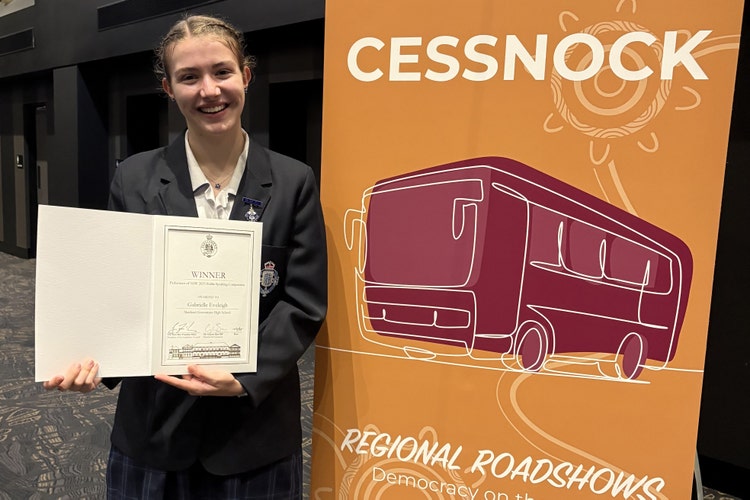 Student holding a award at an academic competitions