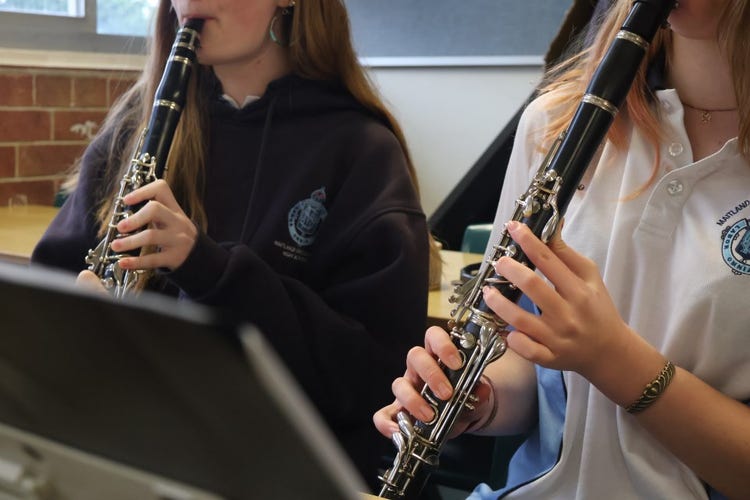 Two students playing clarinets.